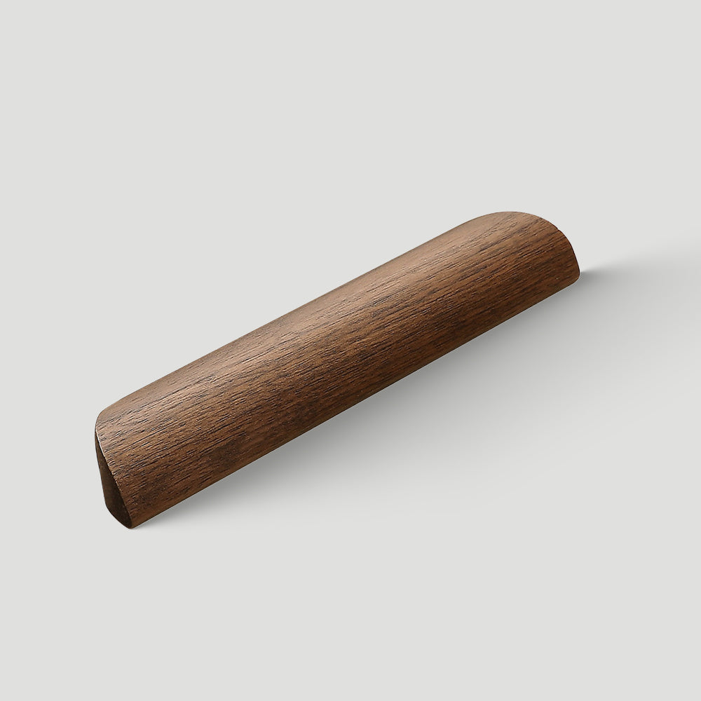 Low-profile walnut cabinet pull in black walnut with 160 mm centers, shown alone at an angle on a light background