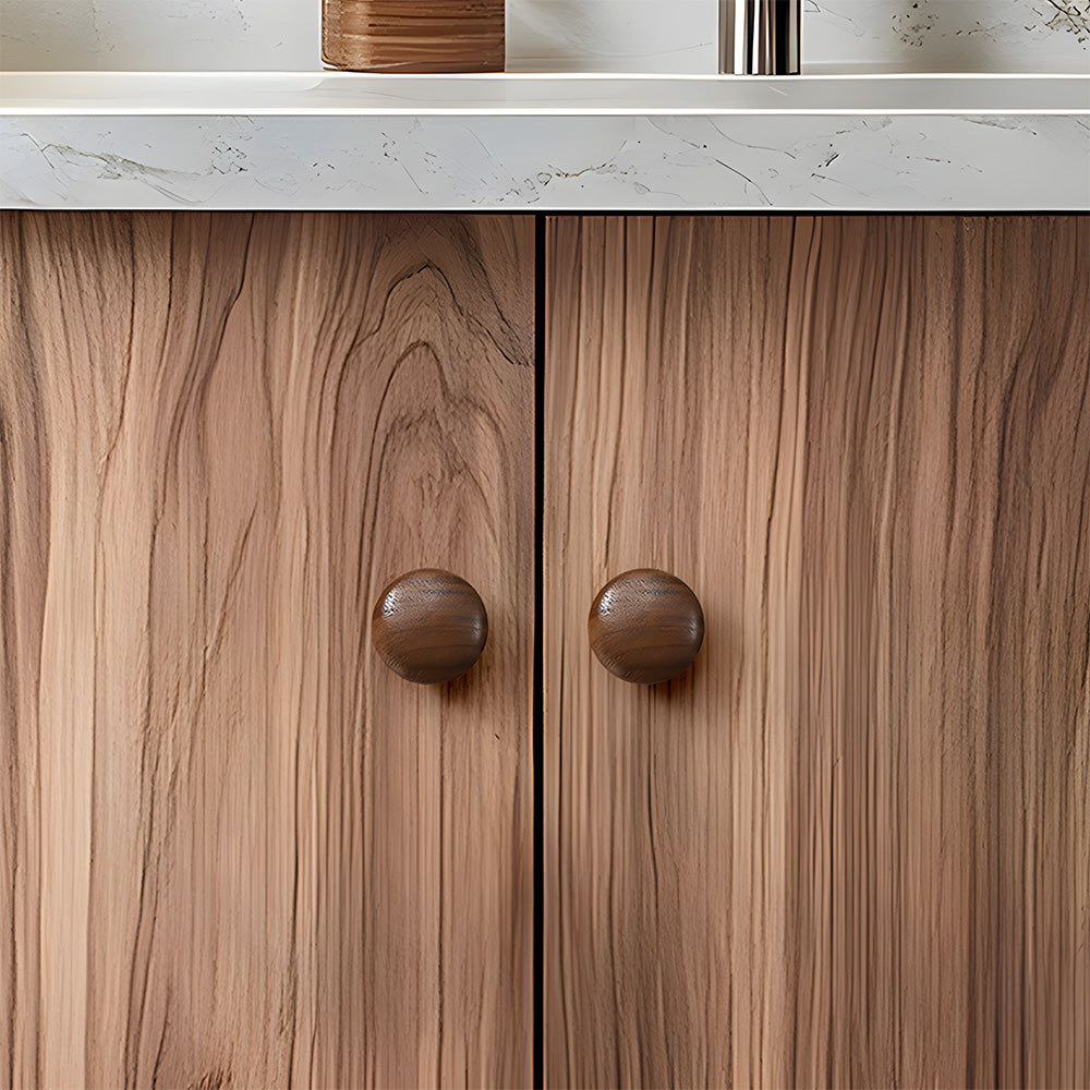Low-profile walnut cabinet pull as a black walnut single-hole version, installed on paired cabinet doors in a close view