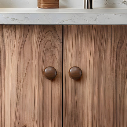 Low-profile walnut cabinet pull as a black walnut single-hole version, installed on paired cabinet doors in a close view