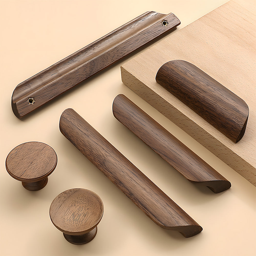 Minimalist walnut wood cabinet pull with a low curved profile, arranged together for a size and style comparison
