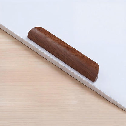 Low-profile walnut cabinet pull, shown alone in a clean front view on a pale background