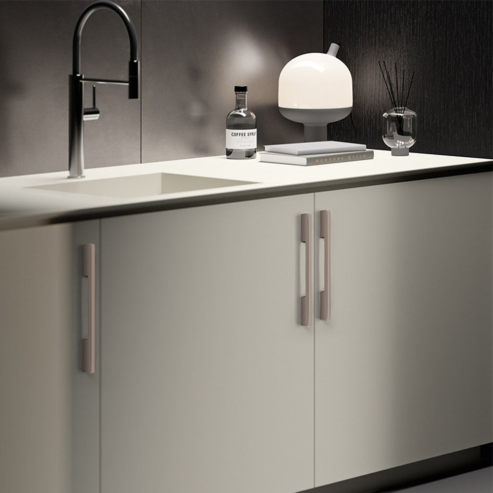 Slim rectangular aluminum cabinet pull, presented for reference installed on cabinetry in context