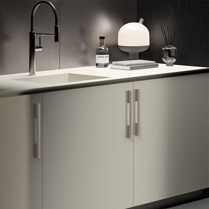 Slim rectangular aluminum cabinet pull, presented for reference installed on cabinetry in context
