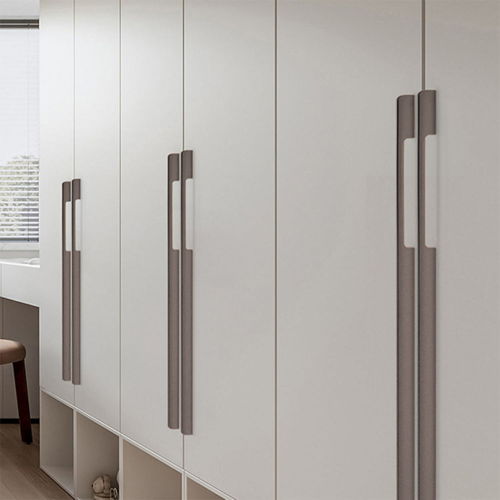 Slim rectangular aluminum cabinet pull, shown at close range installed on cabinetry in context