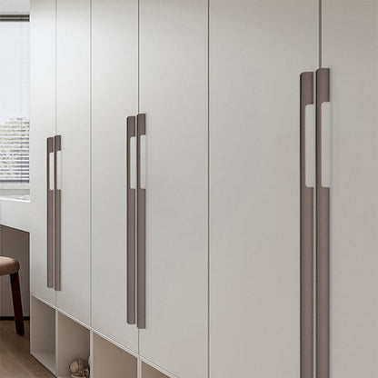 Slim rectangular aluminum cabinet pull, shown at close range installed on cabinetry in context