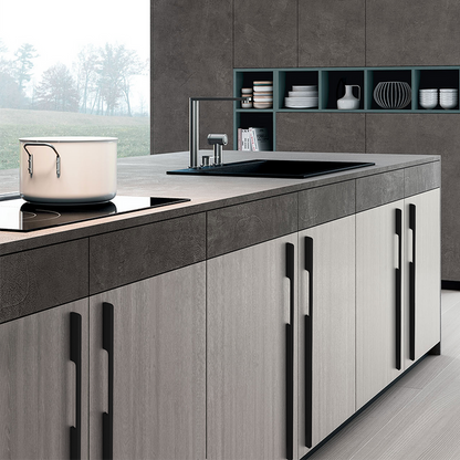 Black slim rectangular aluminum cabinet pull, shown clearly installed on cabinetry in context