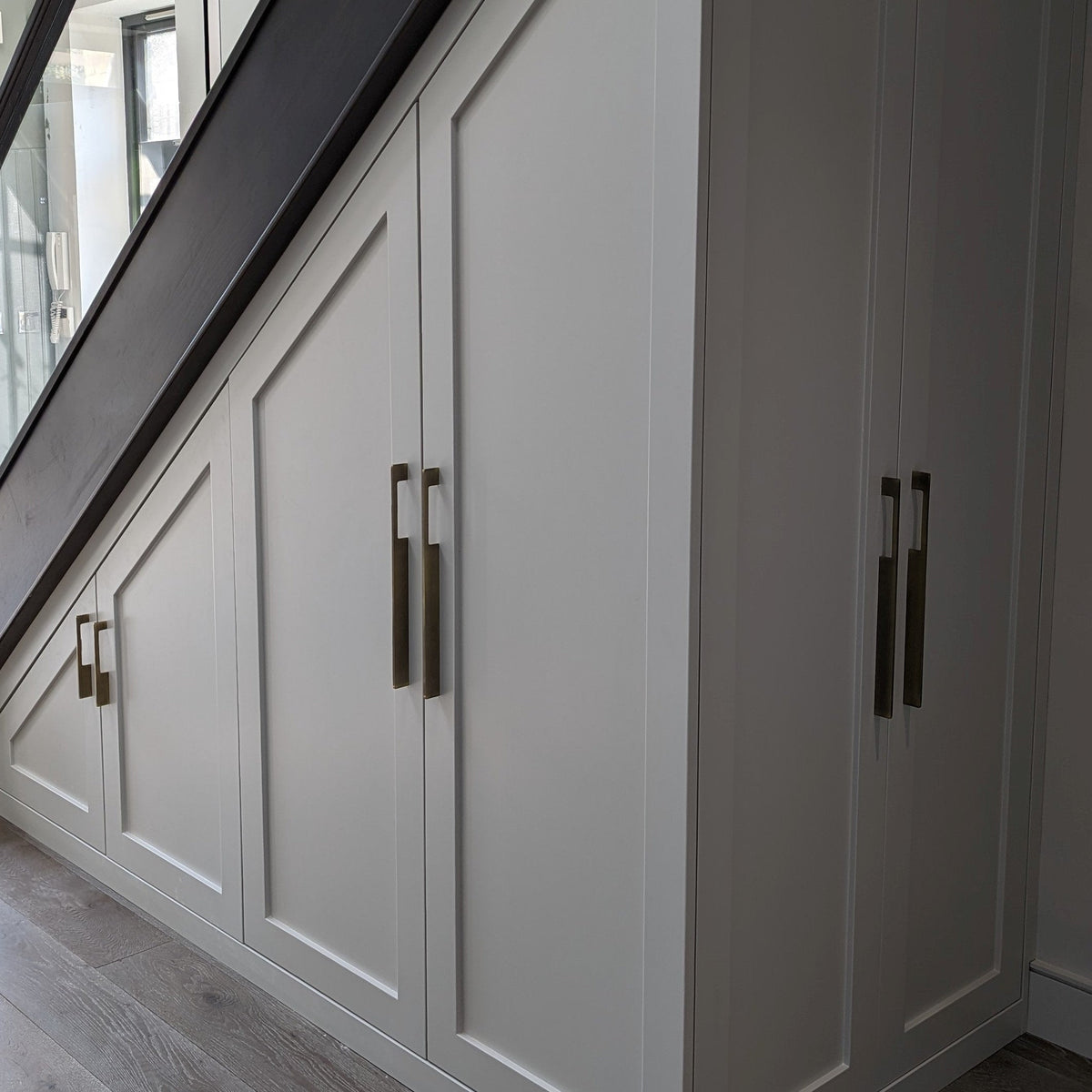 Bronze slim rectangular aluminum cabinet pull, presented for reference mounted on a finished cabinet front