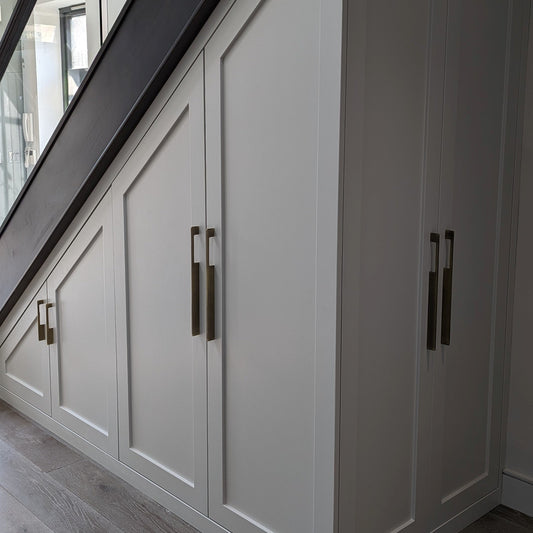 Bronze slim rectangular aluminum cabinet pull, presented for reference mounted on a finished cabinet front