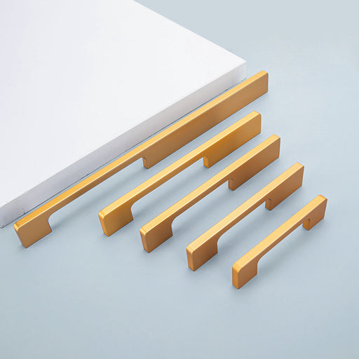 Gold slim rectangular aluminum cabinet pull, displayed from the side as a color and finish lineup
