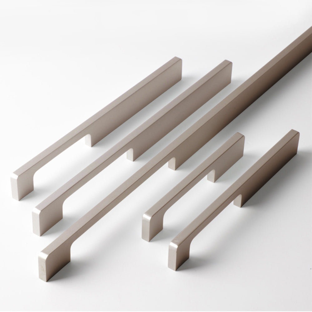 Slim rectangular aluminum cabinet pull, shown from one angle as a color and finish lineup