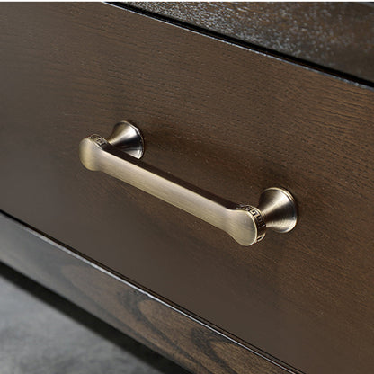 Traditional cabinet pull with flared mounts and knob, pictured in one view in an installed cabinet close-up