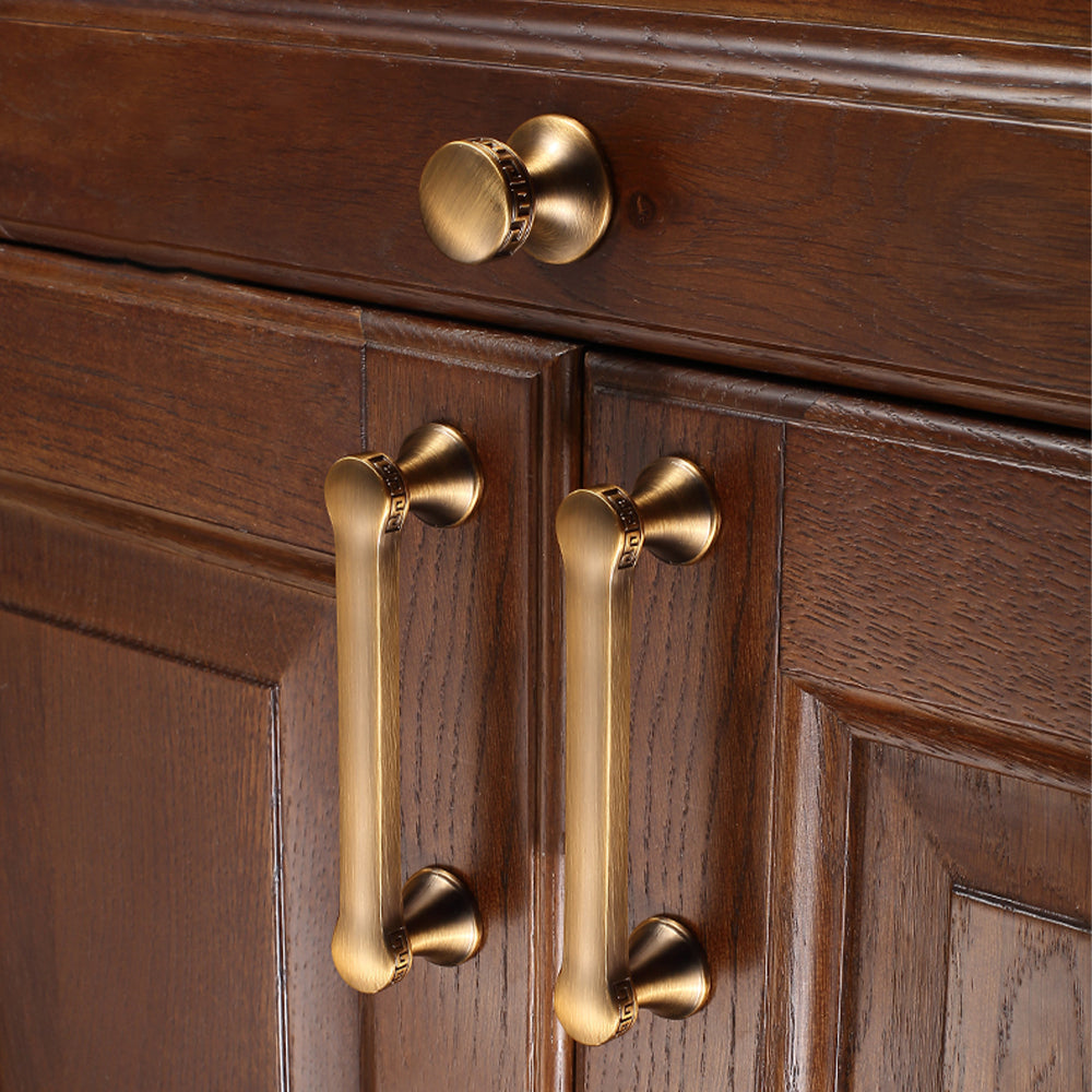 Traditional cabinet pull with flared mounts and knob, shown clearly installed on cabinetry in context