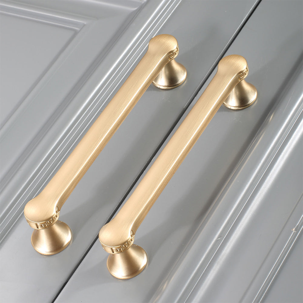 Traditional cabinet pull with flared mounts and knob, shown from one angle in an installed cabinet close-up