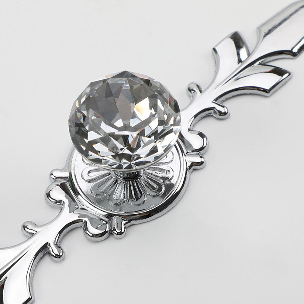 Faceted crystal cabinet knob with ornate leaf backplate, shown clearly with its construction and finish visible