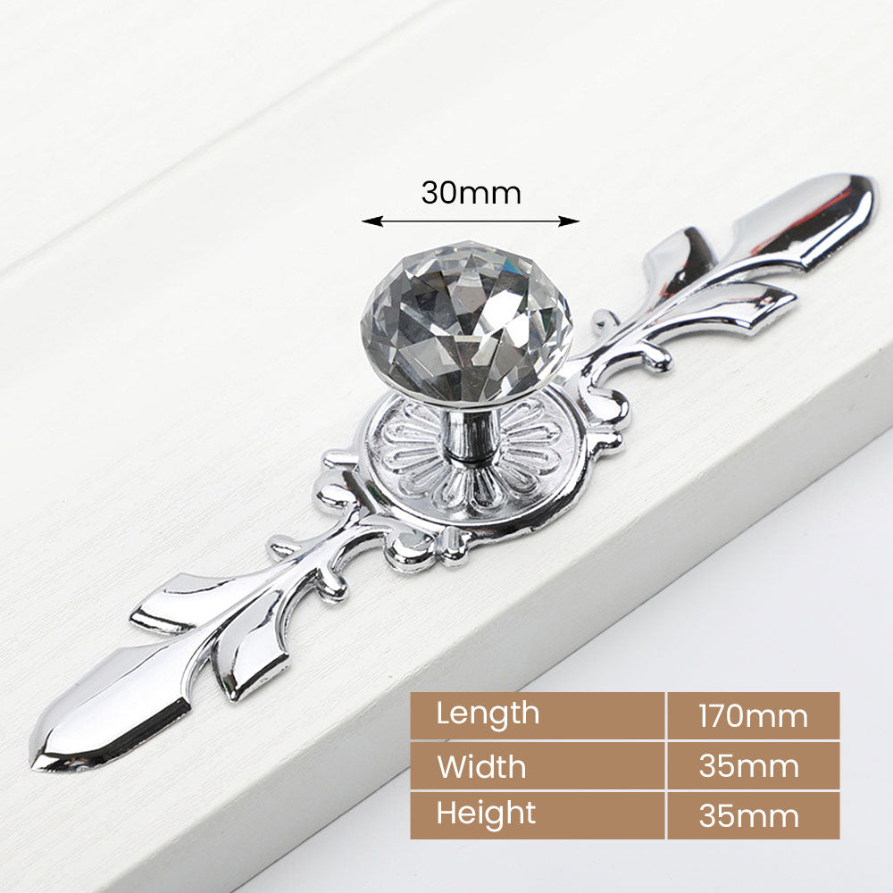 Faceted crystal cabinet knob with ornate leaf backplate, shown from one angle with dimensions and centers labeled