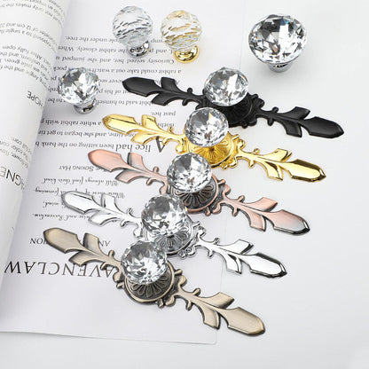 Faceted crystal cabinet knob with ornate leaf backplate, shown clearly as a color and finish lineup