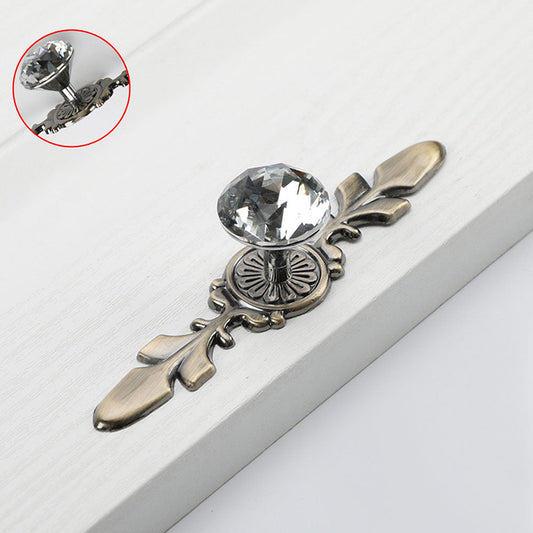 Faceted crystal cabinet knob with ornate leaf backplate, pictured in one view with its construction and finish visible