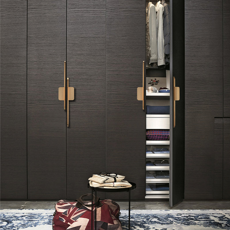 Long zinc cabinet pull with rectangular center plate, shown from one angle installed on cabinetry in context