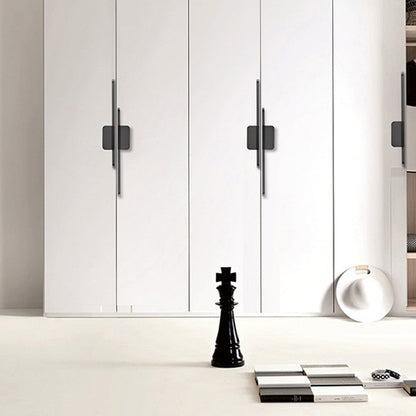 Long zinc cabinet pull with rectangular center plate, pictured in one view installed on cabinetry in context