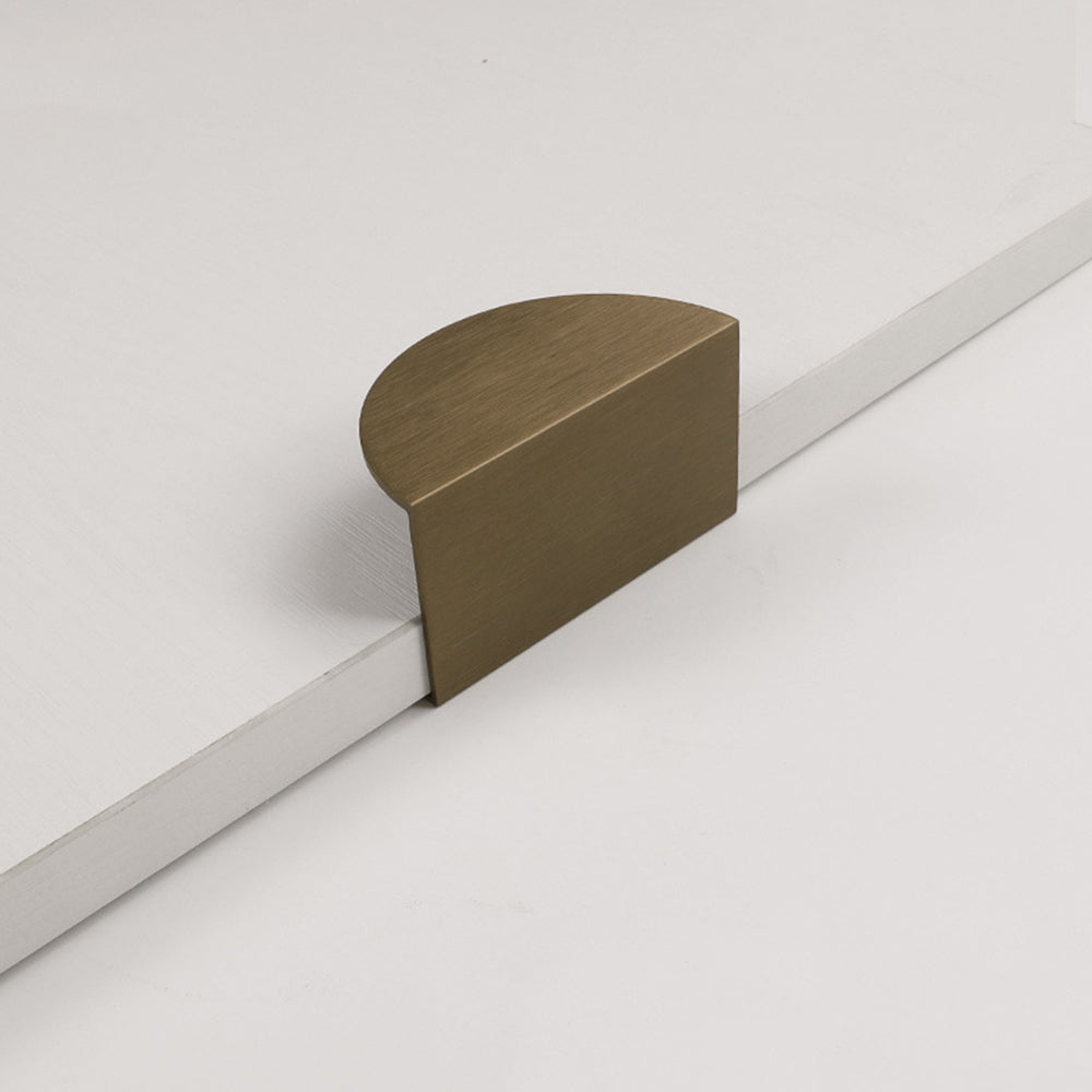 Bronze half-moon cabinet edge pull, displayed from the side on a clean neutral background