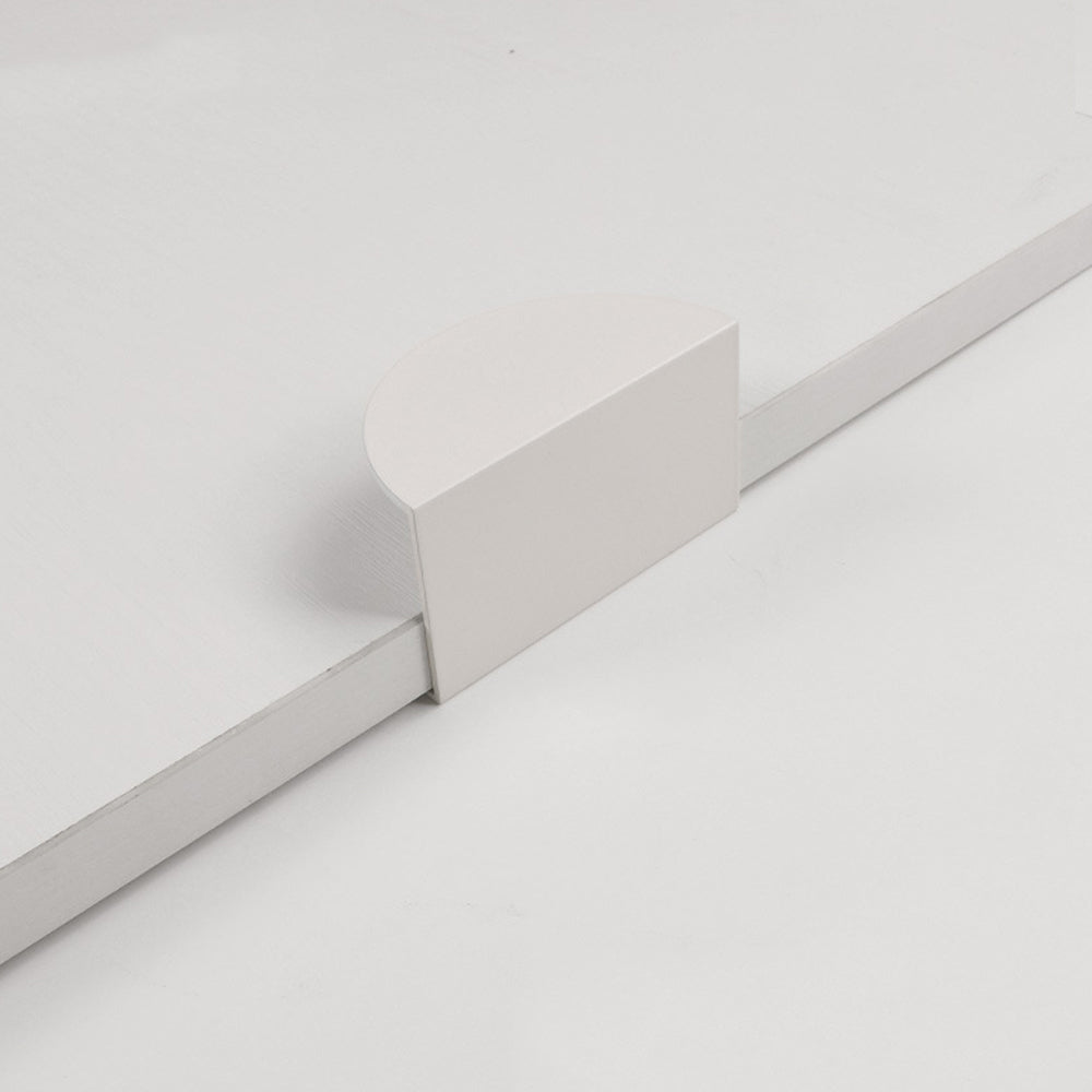 White half-moon cabinet edge pull, shown in a focused view on a clean neutral background