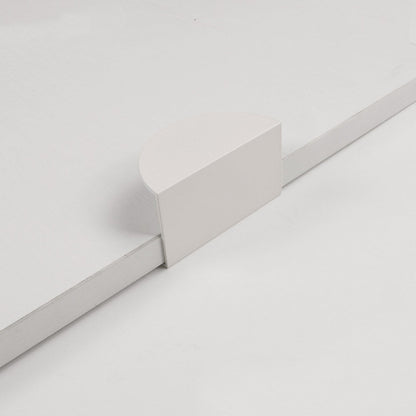 White half-moon cabinet edge pull, shown in a focused view on a clean neutral background