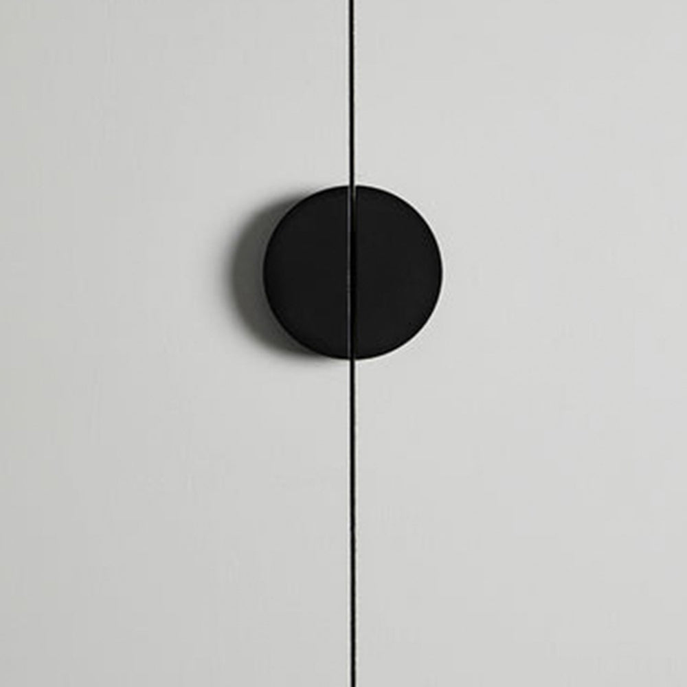 Black half-moon cabinet edge pull, shown clearly in an installed cabinet close-up