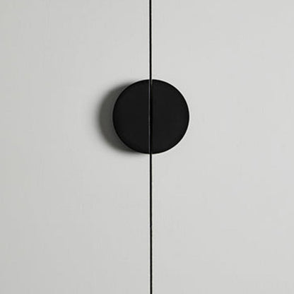 Black half-moon cabinet edge pull, shown clearly in an installed cabinet close-up