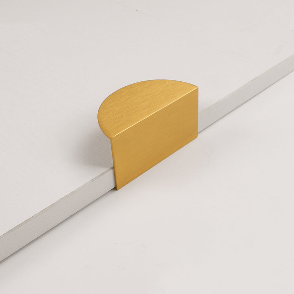 Gold half-moon cabinet edge pull, shown from one angle on a clean neutral background