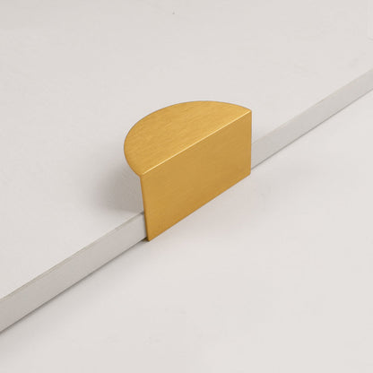 Gold half-moon cabinet edge pull, shown from one angle on a clean neutral background
