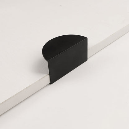 Half-moon cabinet edge pull, presented for reference on a clean neutral background