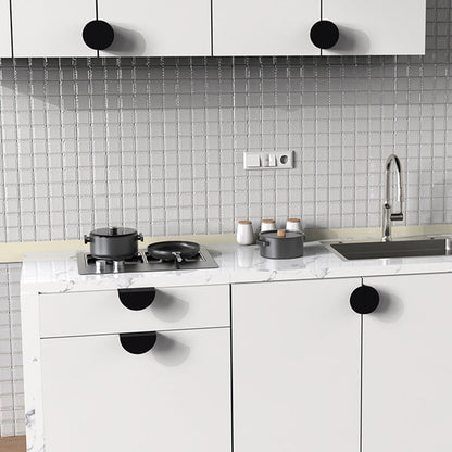 Black half-moon cabinet edge pull, shown from one angle installed on cabinetry in context