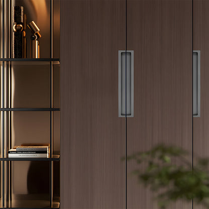 Gray concealed slotted cabinet pull, shown at close range installed on cabinetry in context