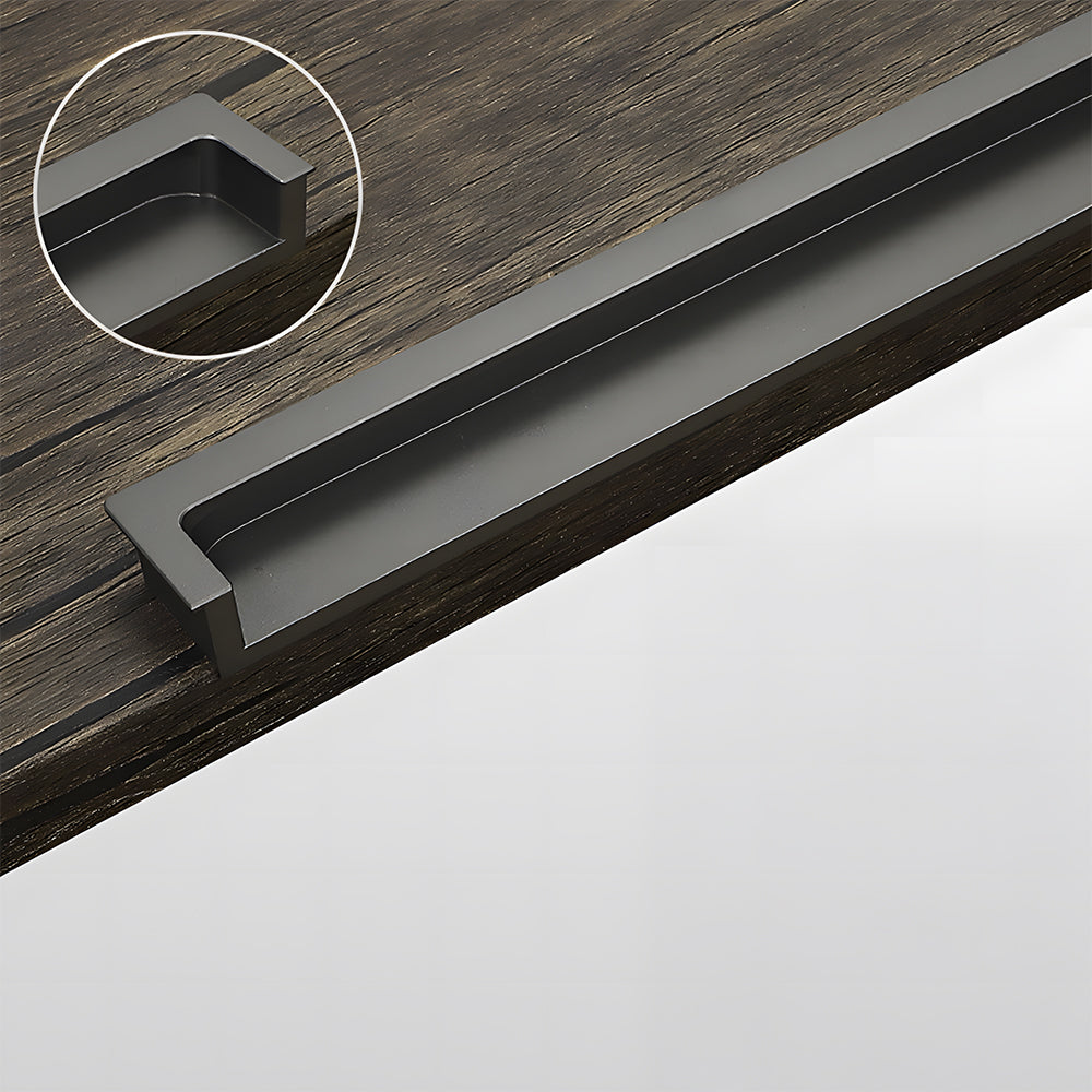 Gray concealed slotted cabinet pull, shown from one angle showing the surface and mounting form