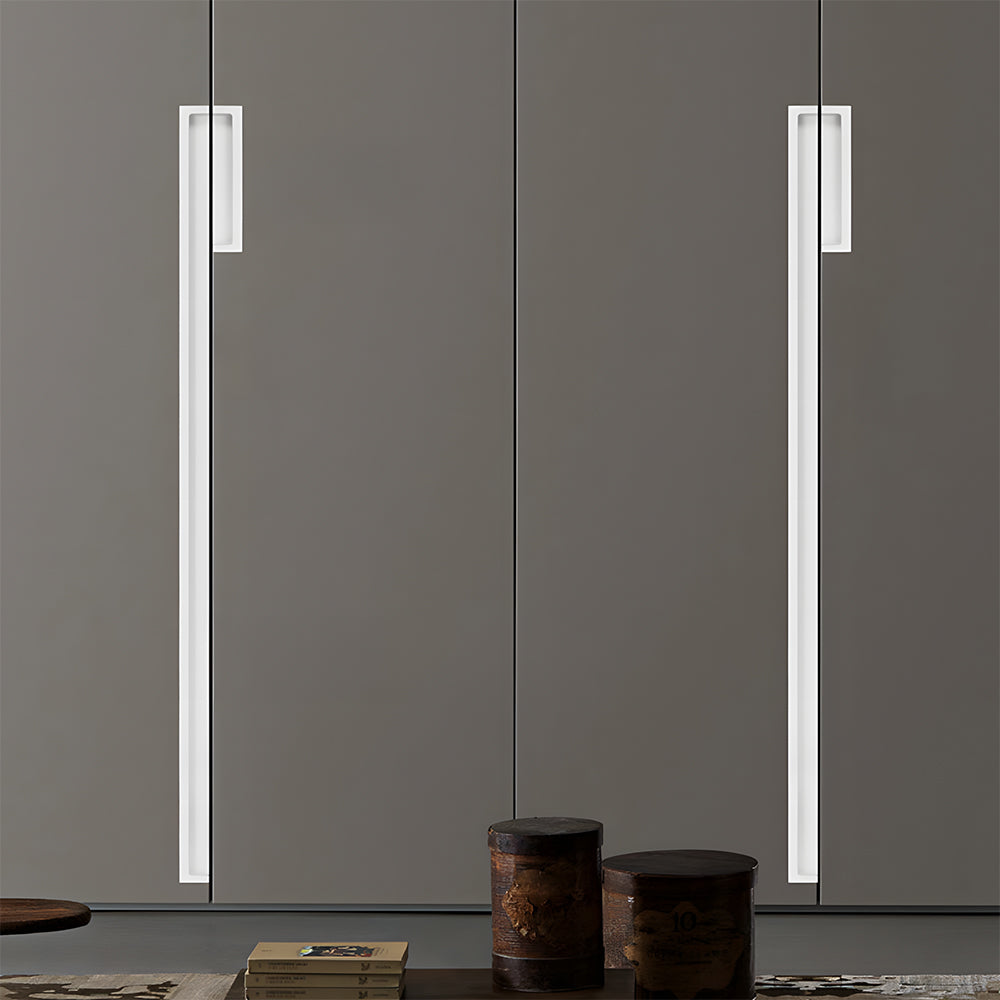 White concealed slotted cabinet pull, displayed from the side installed on cabinetry in context
