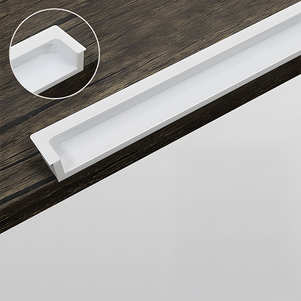 White concealed slotted cabinet pull, shown at close range showing the surface and mounting form