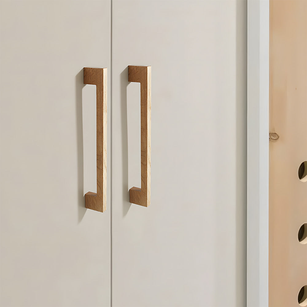 Square wood cabinet pull in beech with 192 mm centers, installed on paired cabinet doors in a close view