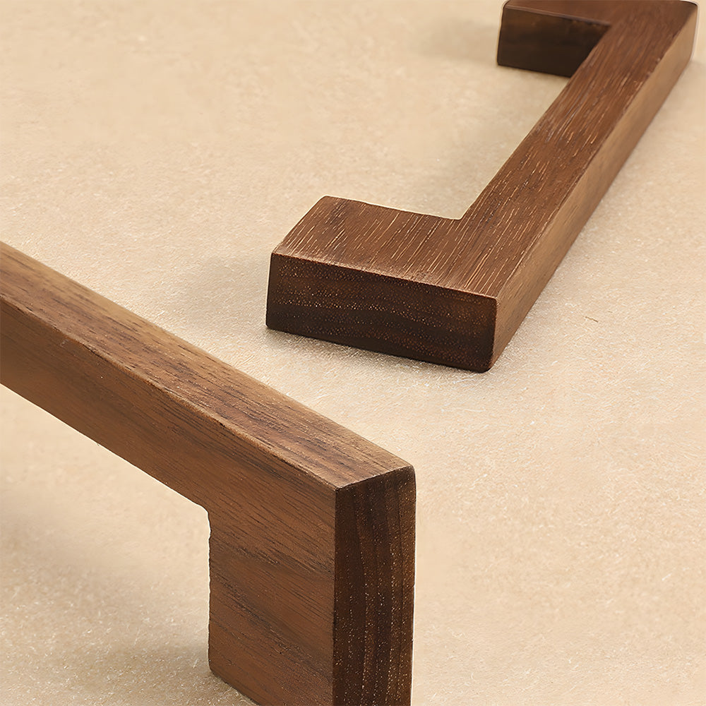 Square wood cabinet pull with right-angle legs, shown in side profile against a white cabinet surface