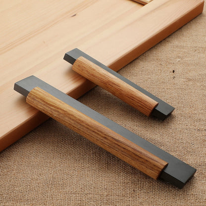 Wood cabinet pull with metal ends in black with 160 mm centers, arranged together from an overhead angle for comparison
