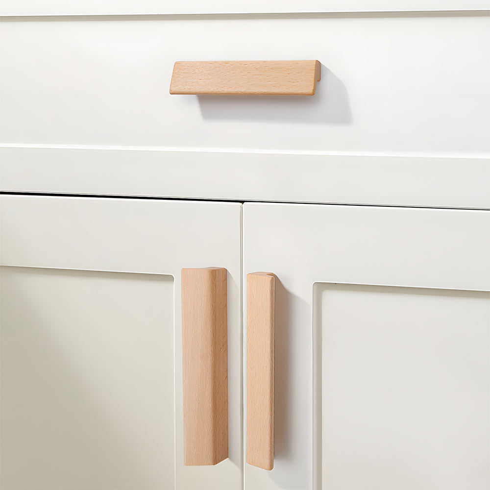 L-shaped wood cabinet handle in style B with 128 mm centers, shown on cabinet fronts in a bright room setting