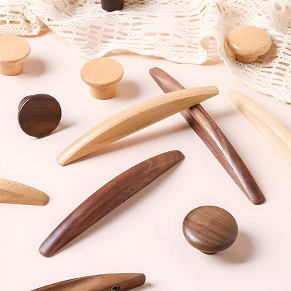 Natural wood cabinet pull with a tapered leaf-shaped profile, grouped on a light surface to compare lengths and profiles