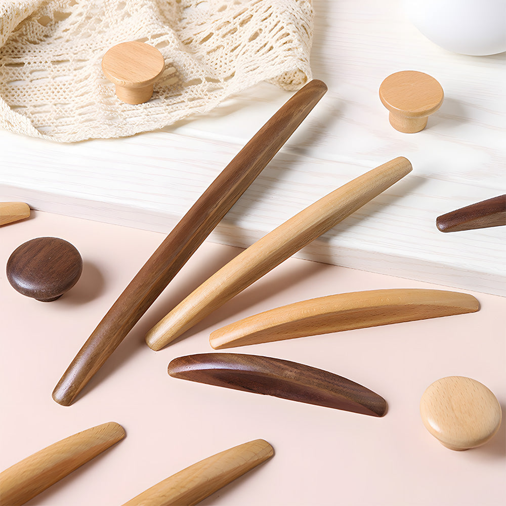 Natural wood cabinet pull with a tapered leaf-shaped profile, arranged together from an overhead angle for comparison