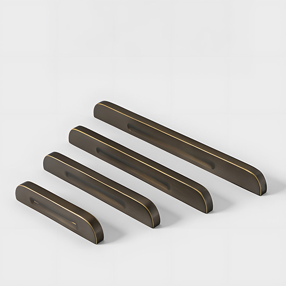 Recessed brass drawer pull with matching cabinet knob, pictured in one view as a color and finish lineup