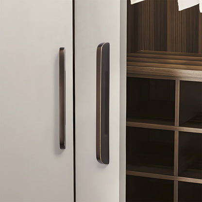 Recessed brass drawer pull with matching cabinet knob, shown at close range installed on cabinetry in context