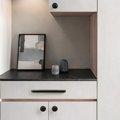 Recessed brass drawer pull with matching cabinet knob, presented in another view installed on cabinetry in context