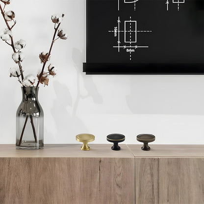 Recessed brass drawer pull with matching cabinet knob, shown from one angle as a color and finish lineup