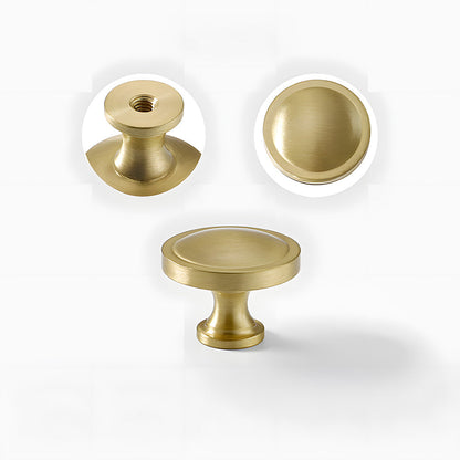Recessed brass drawer pull with matching cabinet knob, shown clearly with its construction and finish visible