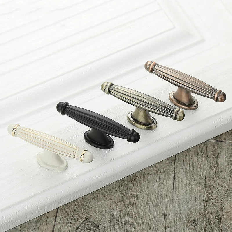 Retro fluted cabinet pull with matching T-bar knob, shown at close range as a color and finish lineup