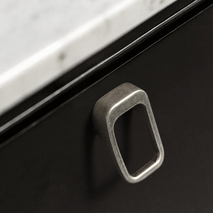 Rounded rectangle cabinet pull, shown clearly in an installed cabinet close-up with key hardware details visible