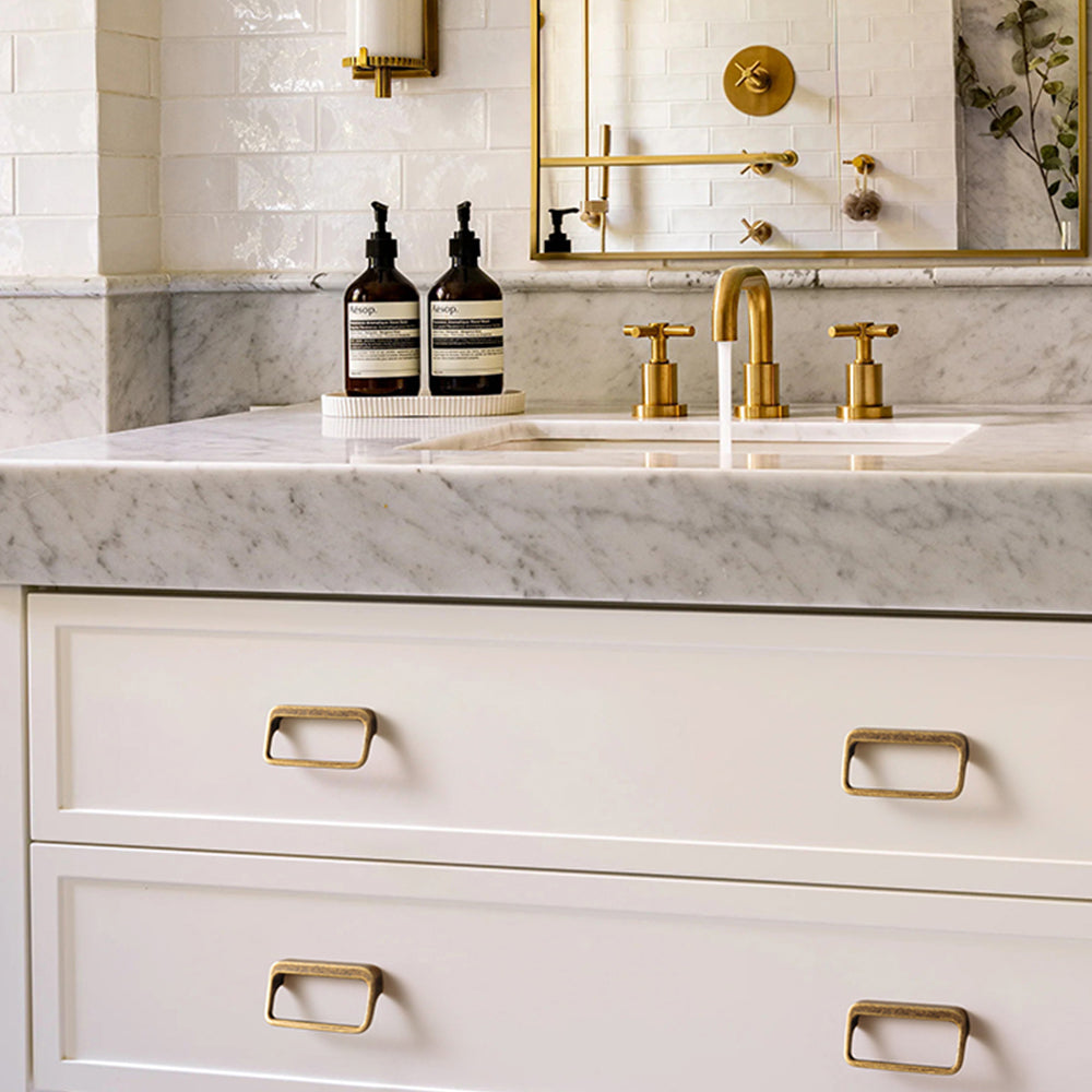 Rounded rectangle cabinet pull, shown clearly installed on cabinetry in context with key hardware details visible